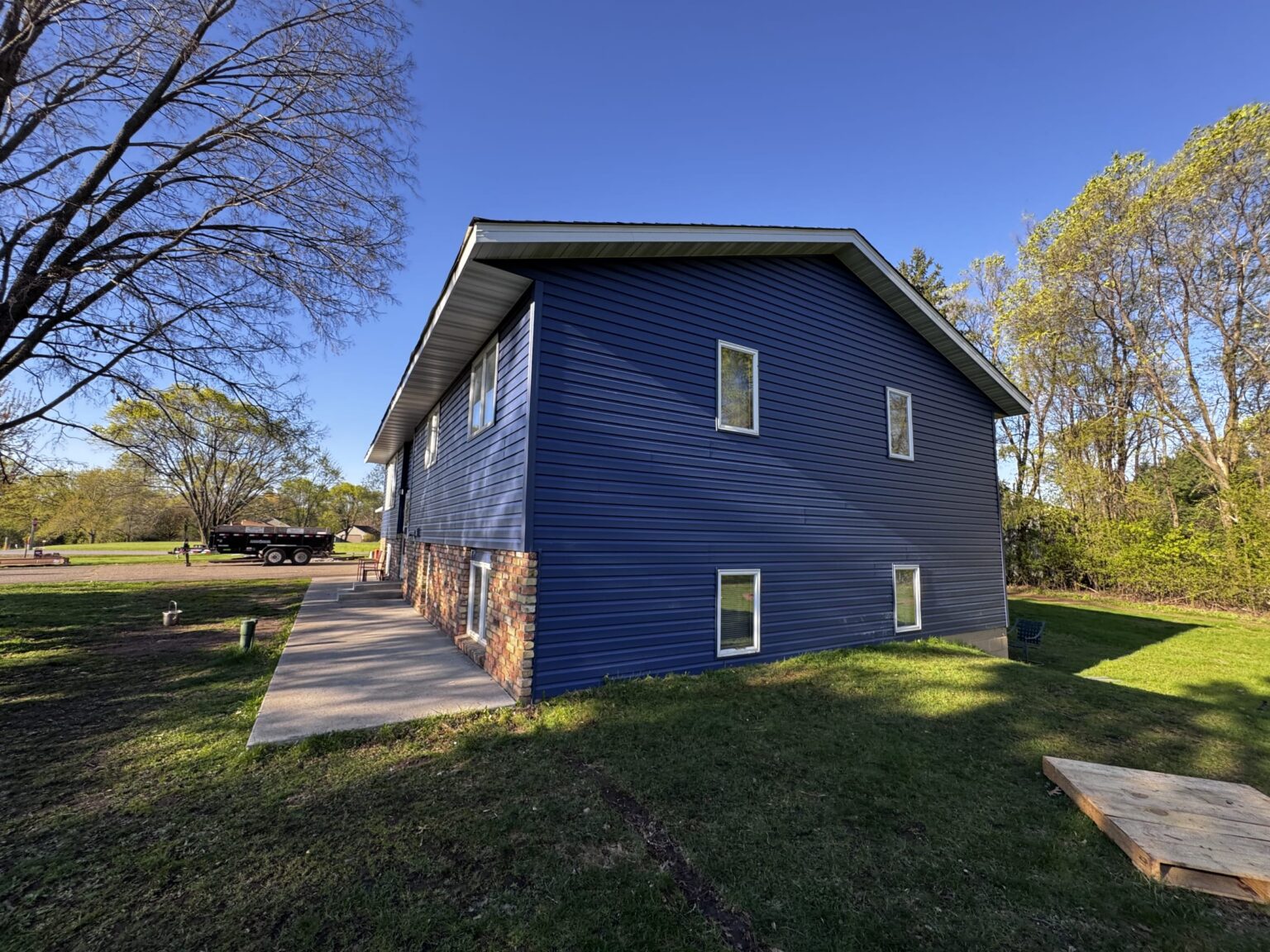 Finished navy siding installation with custom trim, Minnesota home